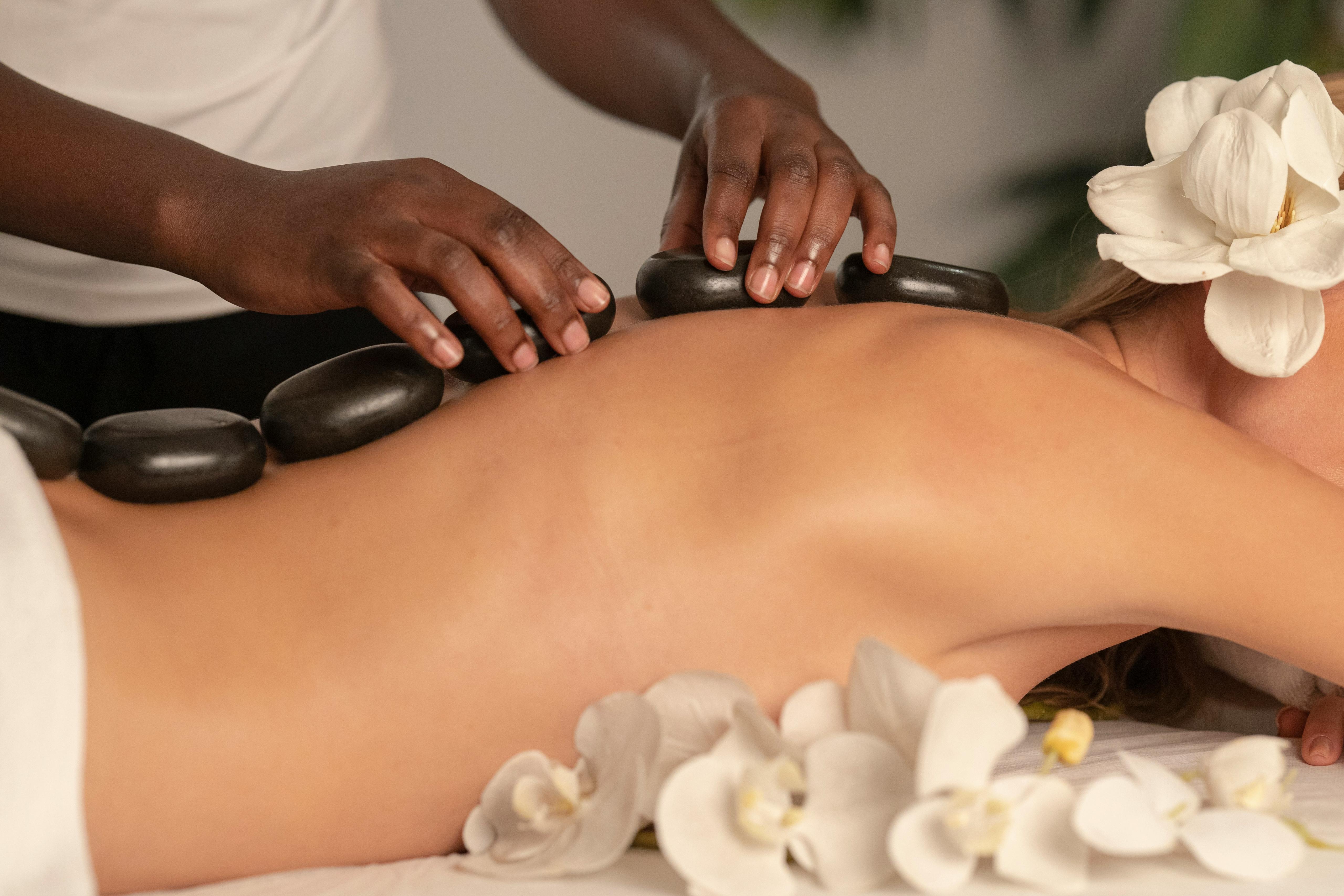 Relaxing hot stone massage with orchids